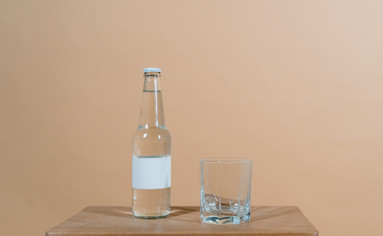 Close-Up Shot of a Glass beside a Bottle